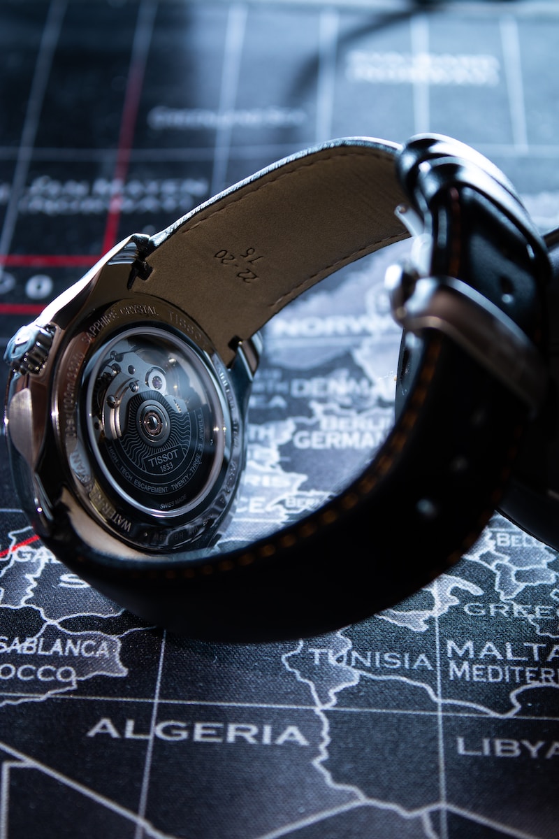 a close up of a watch on a map